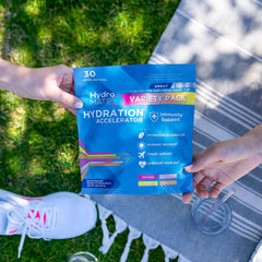 HydroMATE packets poured into a bottle for quick on the go hydration.