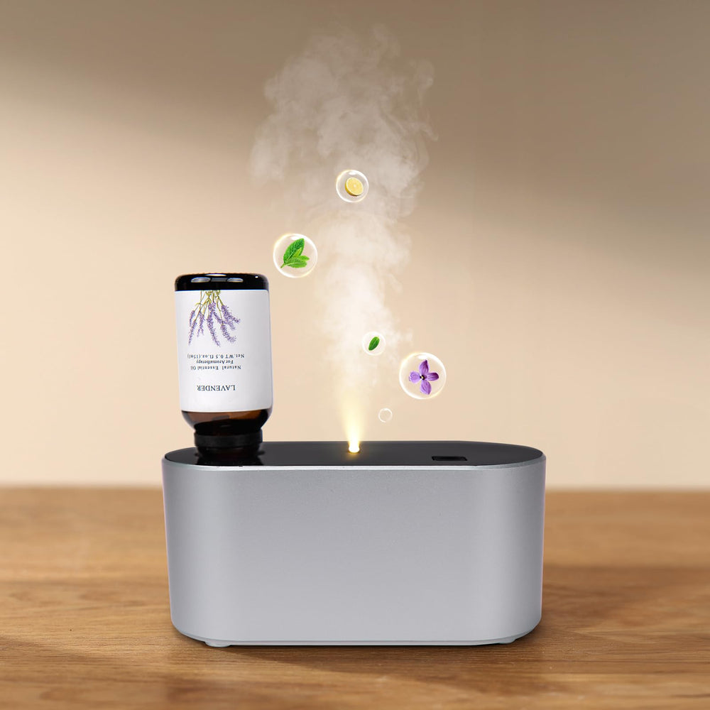Nexalithron waterless diffuser in silver on desk delivering subtle home fragrance