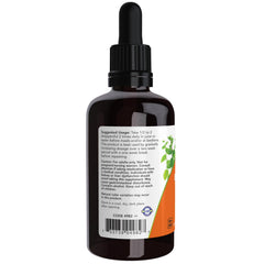 NOW Foods Green Black Walnut Wormwood Complex being poured into juice for easy daily intake