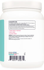 Pouring Nutricost blue raspberry powder into a glass for easy mix.