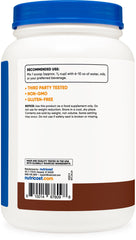 Nutricost whey chocolate serving spoon shows quick mix option.