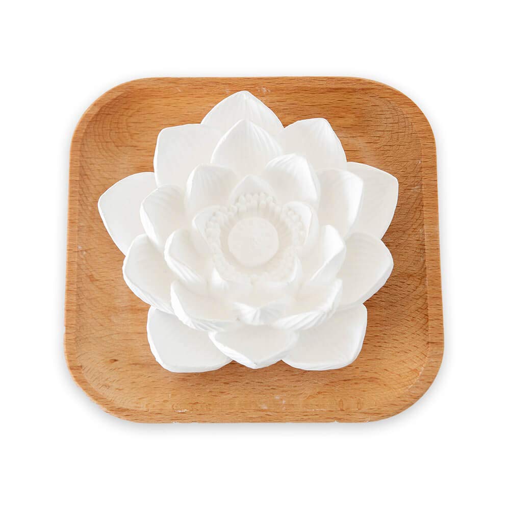 Plant Therapy passive lotus bloom diffuser on a wood base releasing a subtle aroma.