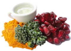 Pomi-T ingredients display with broccoli, turmeric, pomegranate, and green tea.