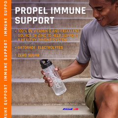 Propel Immune Support Powder Lemon Blackberry scoop resting beside a prepared drink.
