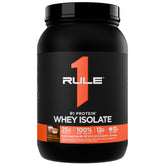 Rule 1 Proteins R1 Whey Isolate bottle on counter, fast-acting protein for post-workout recovery.