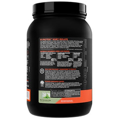 Scoop beside glass showing 25g protein and 6g BCAA per serving