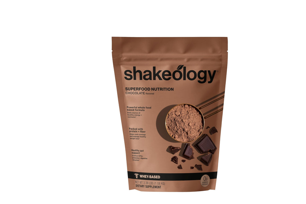 Shakeology 0g Added Sugar whey blend pours chocolate shake for a protein boost
