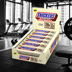 Snickers white chocolate bar close-up highlights creamy coating with protein-rich texture.