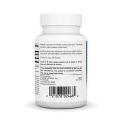 Hands holding melatonin tablet ready for bedtime routine.