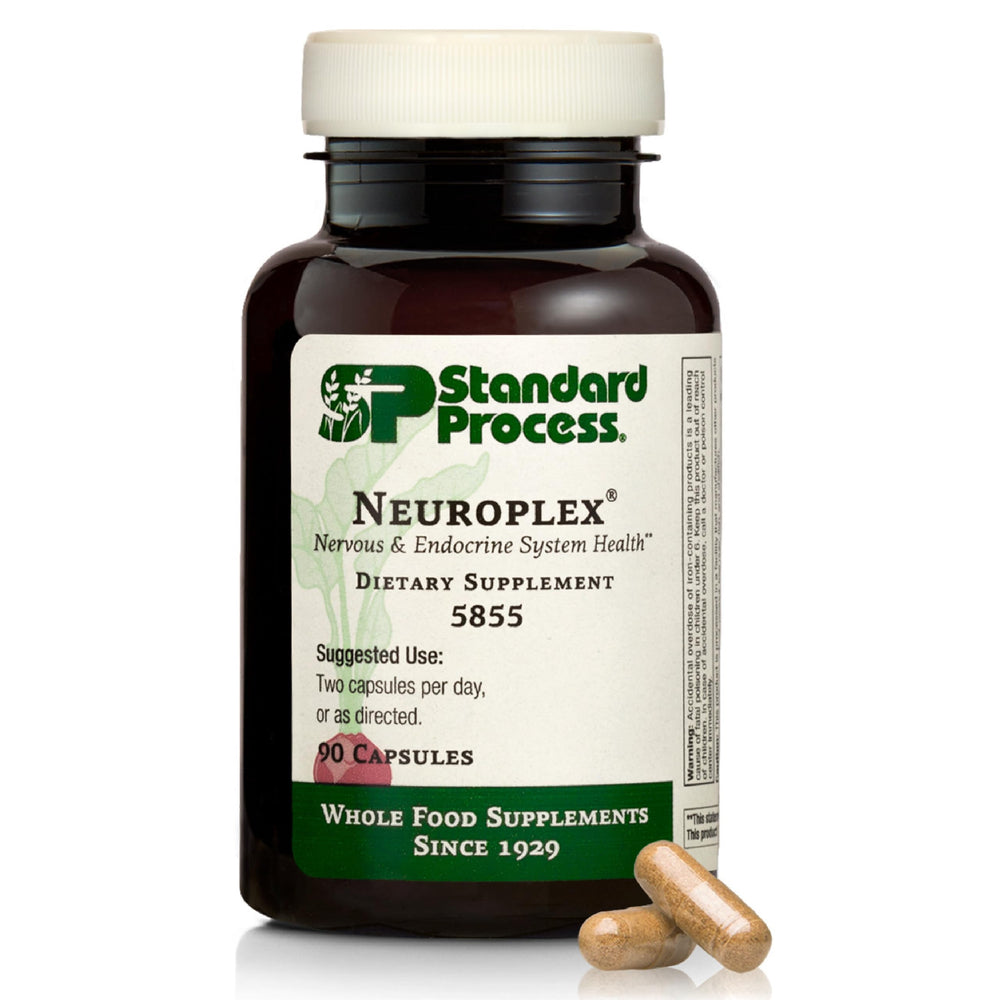 Standard Process Neuroplex bottle on a clean desk, suggesting nervous system support.