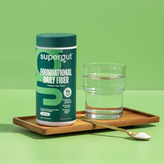 Scoop of Supergut Foundational Daily Fiber ready to mix in beverages.