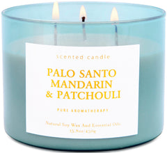 T&H Palo Santo Mandarin Patchouli candle in blue jar close-up, calming ambiance.