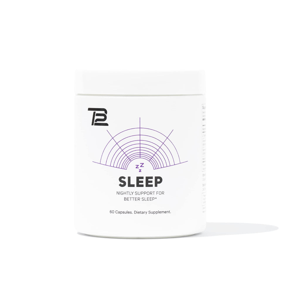 TB12 Sleep bottle on a nightstand promotes calm pre-bed routine.