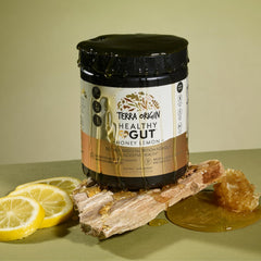 Terra Origin Healthy Gut Powder stirred in a glass of water for easy mixing.