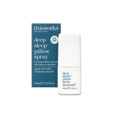 THISWORKS Deep Sleep Pillow Spray bottle on a bedside table for calming nights.