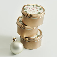 Thymes Travel Tin Frasier Fir burn glow suggests cozy ambiance.