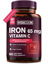 Vitacook iron supplement bottle on kitchen counter with 65 mg iron and vitamin C.