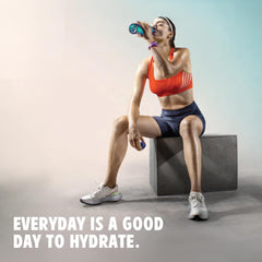 Pouring Vitalyte into bottle to mix a refreshing isotonic drink