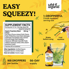 Wild & Organic Uric Acid Cleanse drops being poured in a glass for alcohol-free glycerin base