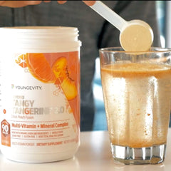 Glass of citrus peach drink prepared with Youngevity BTT2.