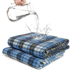 AbleUplift bed pads with blue plaid cover offer discreet night protection.