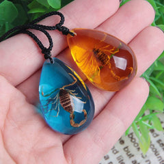 Insect-stone amber pendant detail highlighting vivid scorpion motif