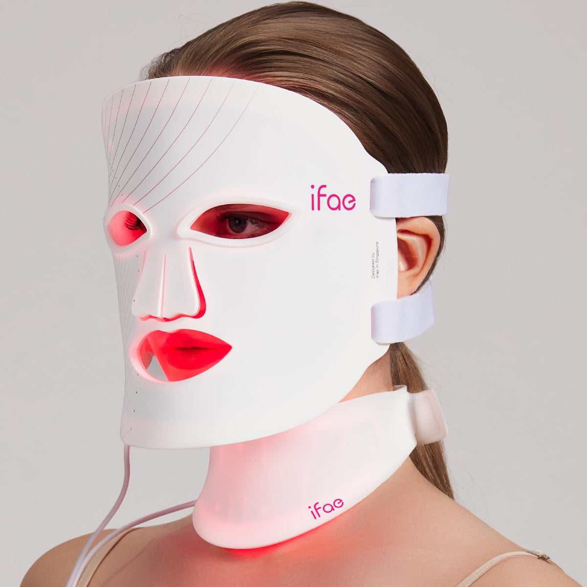 Aesthifae red light therapy mask on the face for at-home rejuvenation.