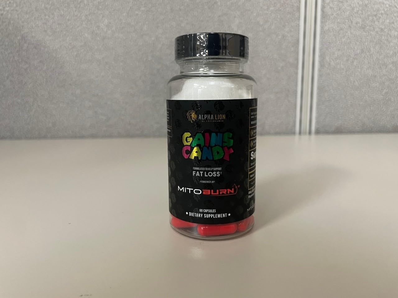 Pouring capsules into hand for quick dose with Gains Candy.