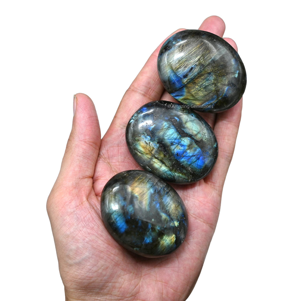 Amazing Gemstone Labradorite palm stone resting on desk for decorative energy hint.