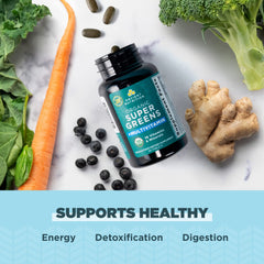 Ancient Nutrition Supergreens bottle beside digestive-friendly foods.