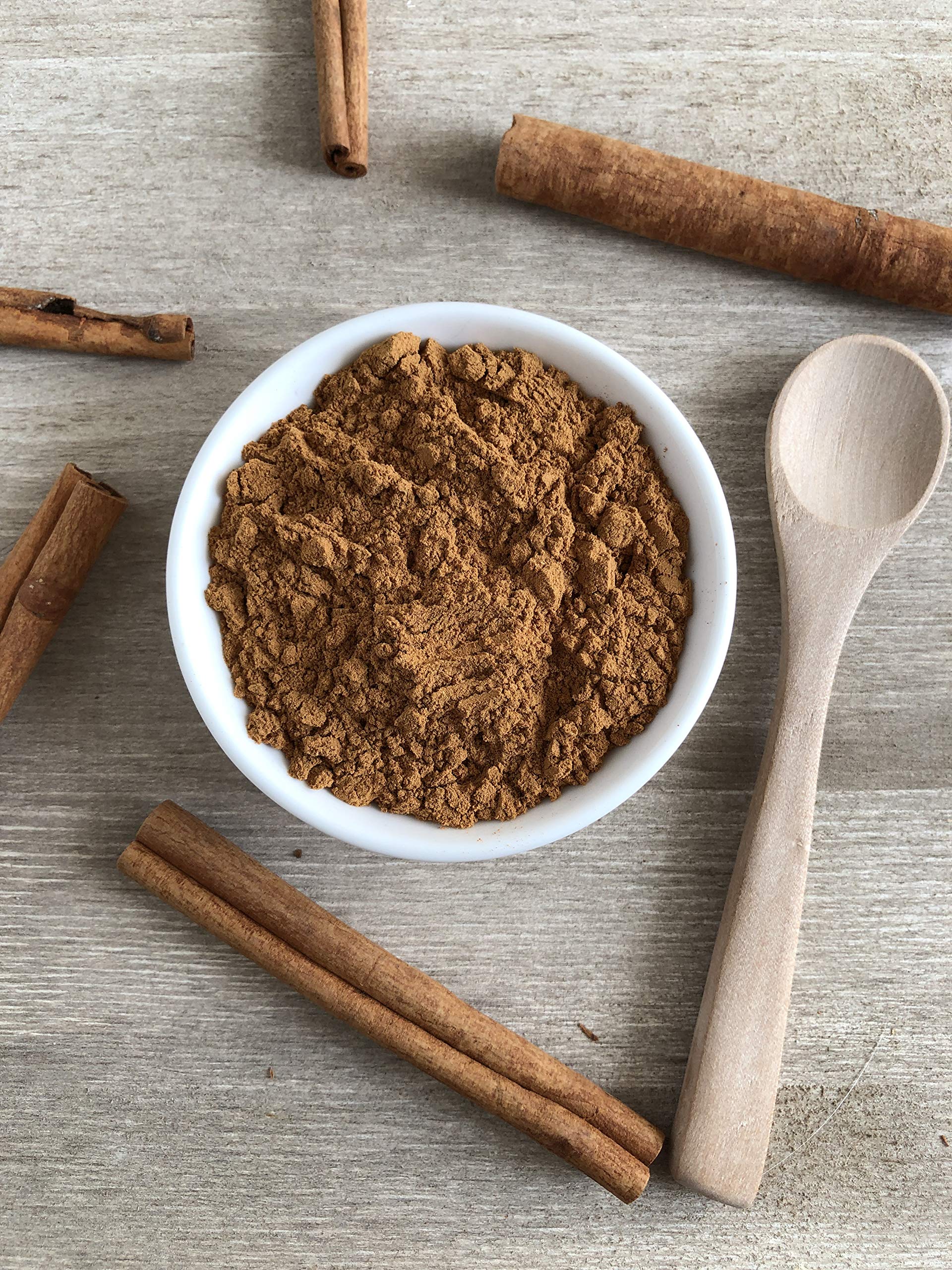 Flatlay with cinnamon sticks and Anthony's powder