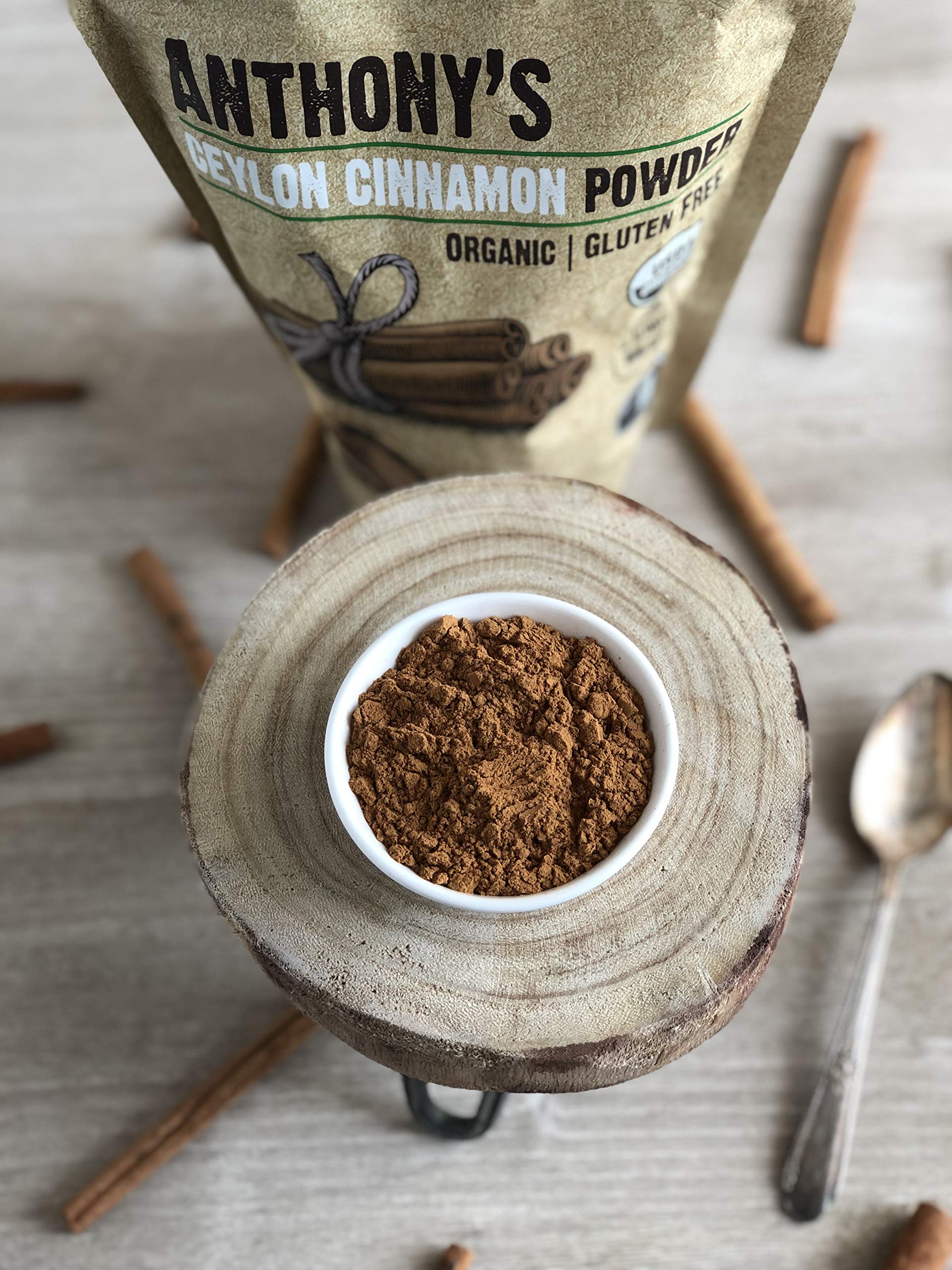 Measuring spoon with Anthony's cinnamon powder beside jar