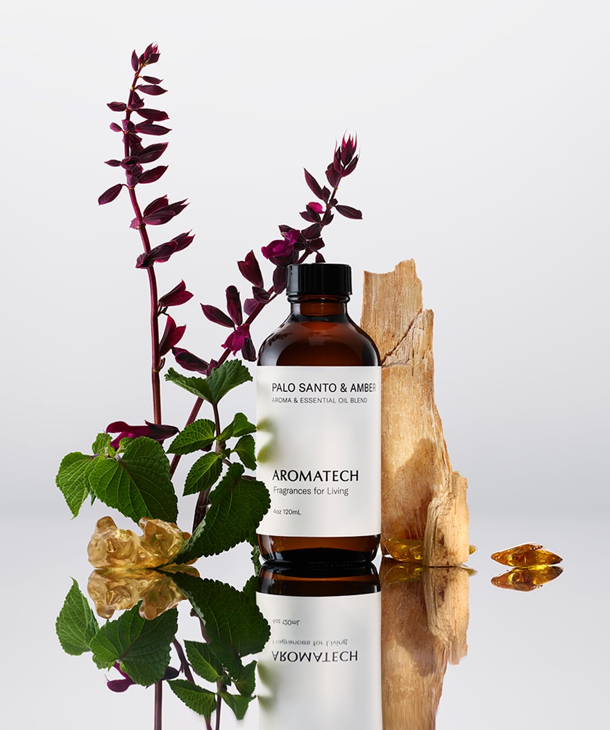AromaTech Palo Santo & Amber 10 ml bottle beside a diffuser for versatile room use.
