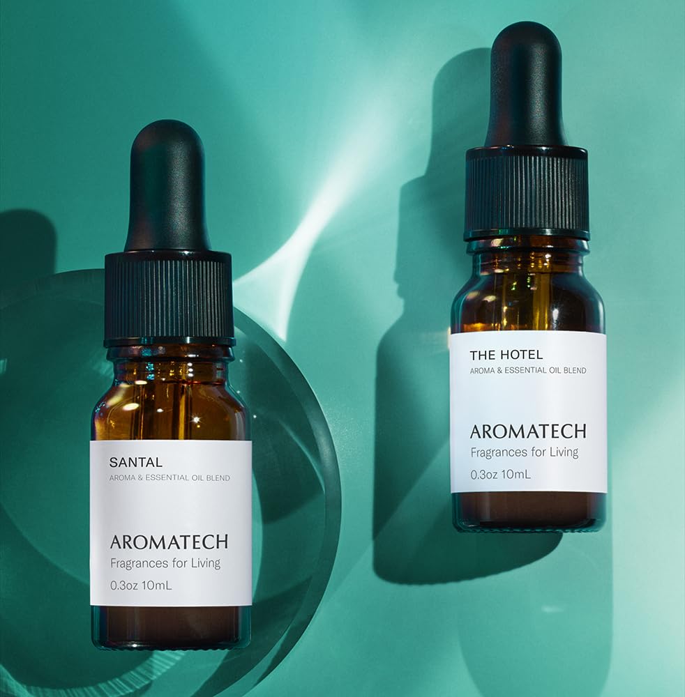 A AromaTech Santal The Hotel diffuser in a bedroom creating a cozy mood.