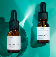 A AromaTech Santal The Hotel diffuser in a bedroom creating a cozy mood.