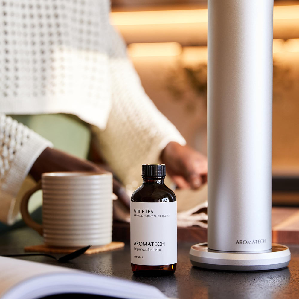 AromaTech White Tea diffuser mist in a tranquil living room setting.