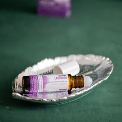 Aura Cacia Lavender Roll-On applied to the wrist for calm and unwind