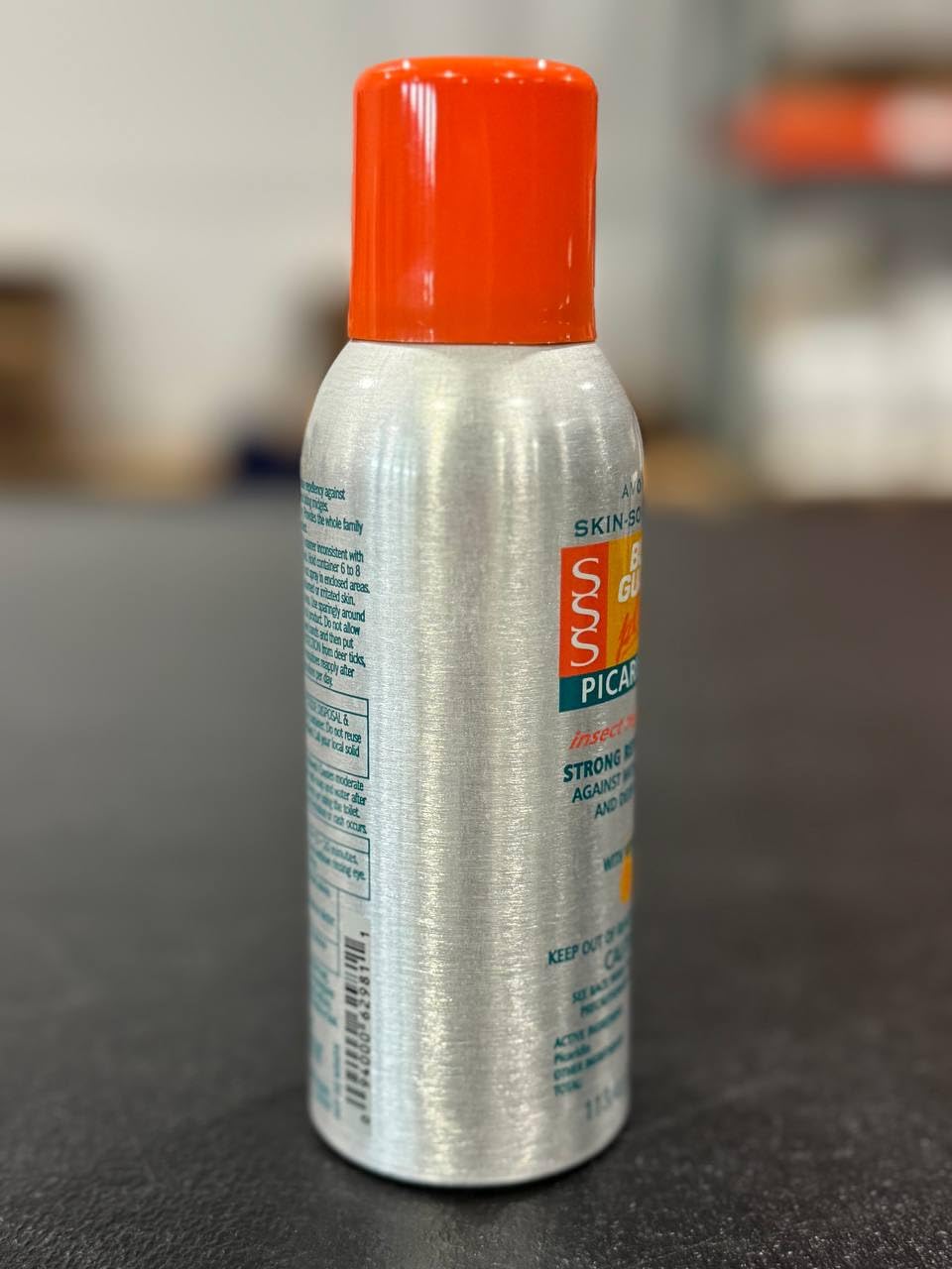 Person applying Avon Bug Guard during outdoor activity.