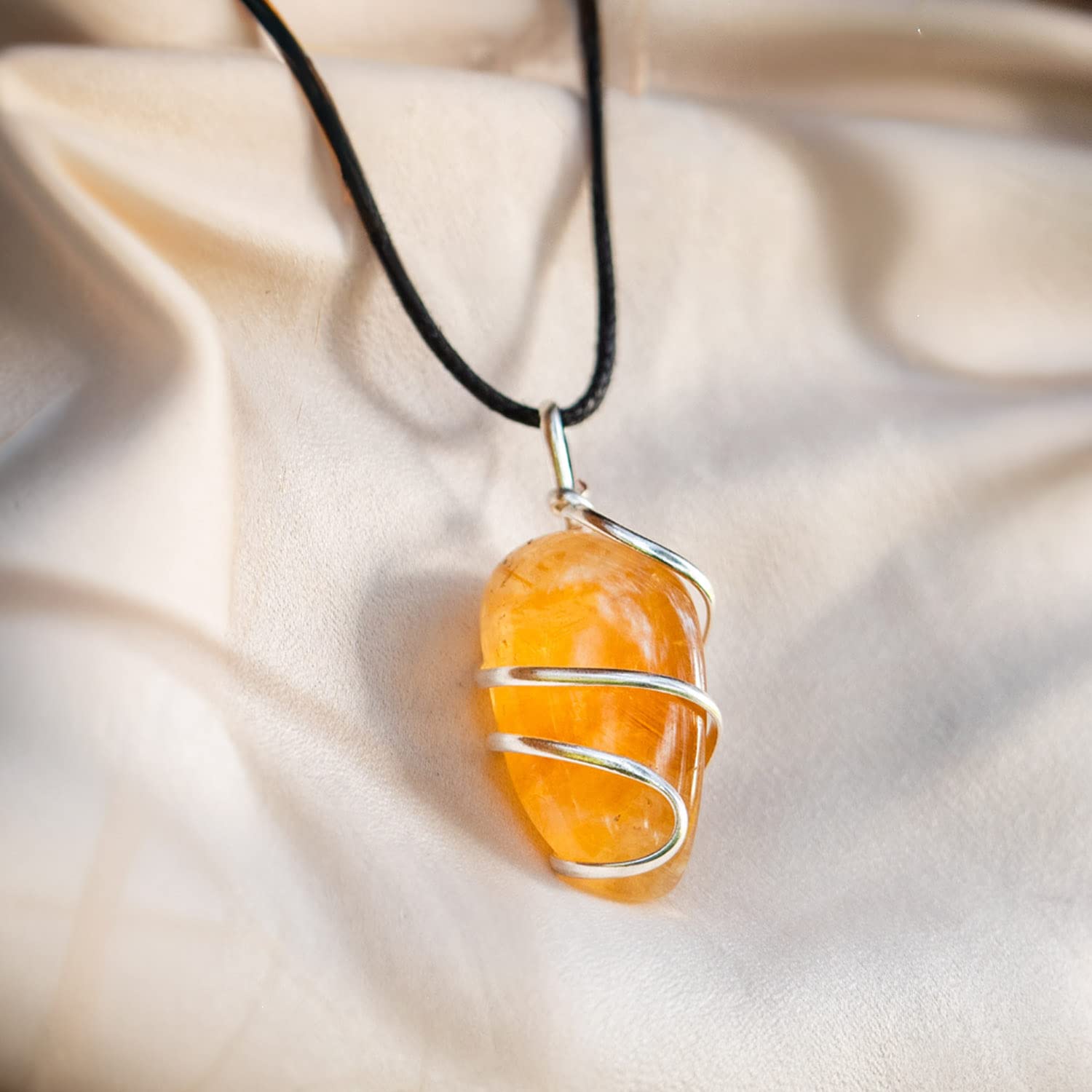 Ayana Wellness Citrine pendant on hand demonstrates versatile accessorizing for any look.