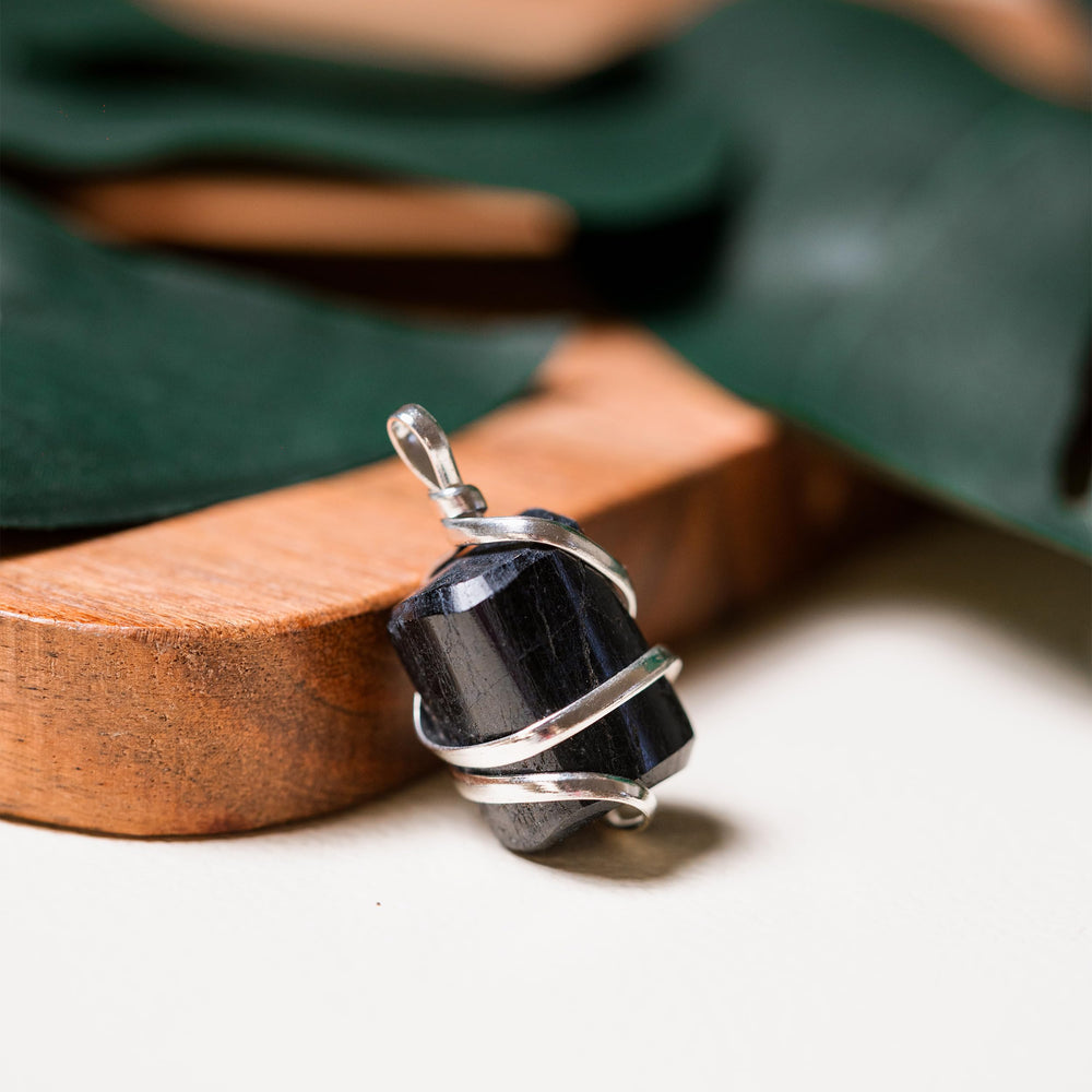 Ayana Wellness pendant worn on neck for grounding and calm.