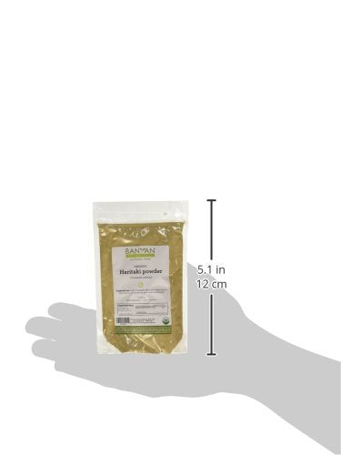 Banyan Botanicals Haritaki Powder ground over a bowl for culinary use.