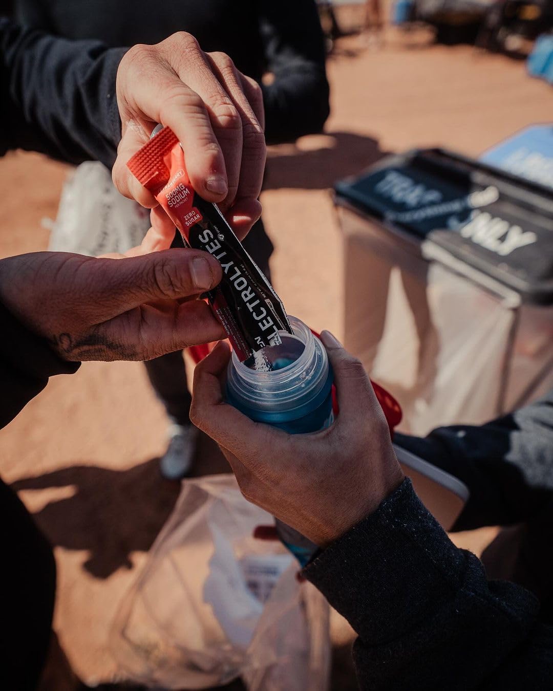 Bare Performance Nutrition electrolytes go packs athlete preparing bottle emphasizes convenient hydration.
