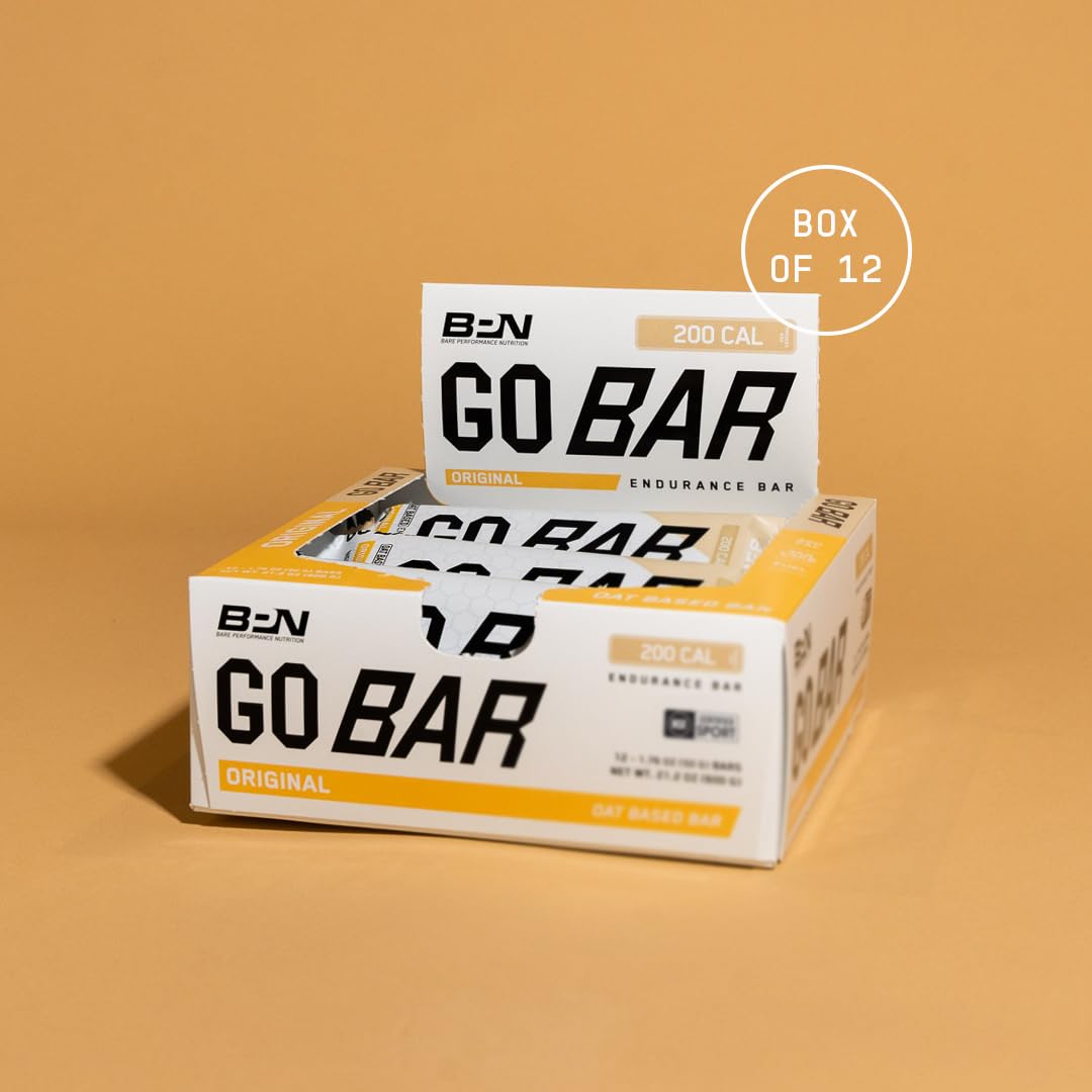 Bare Performance Nutrition Go Bar Original packaging on a bench for on-the-go fueling.