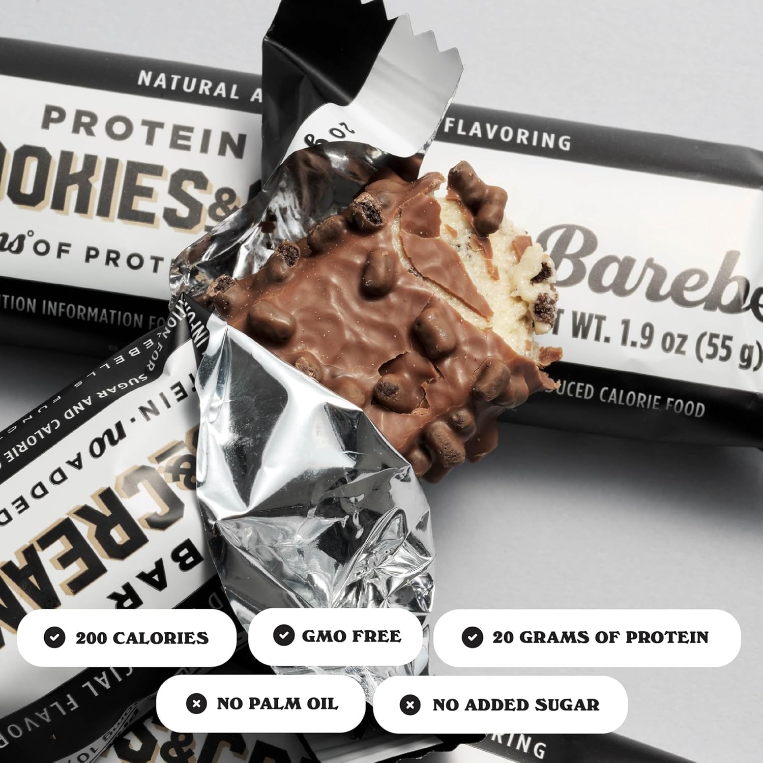 Barebells breakfast setup with cookies and cream bar beside coffee.