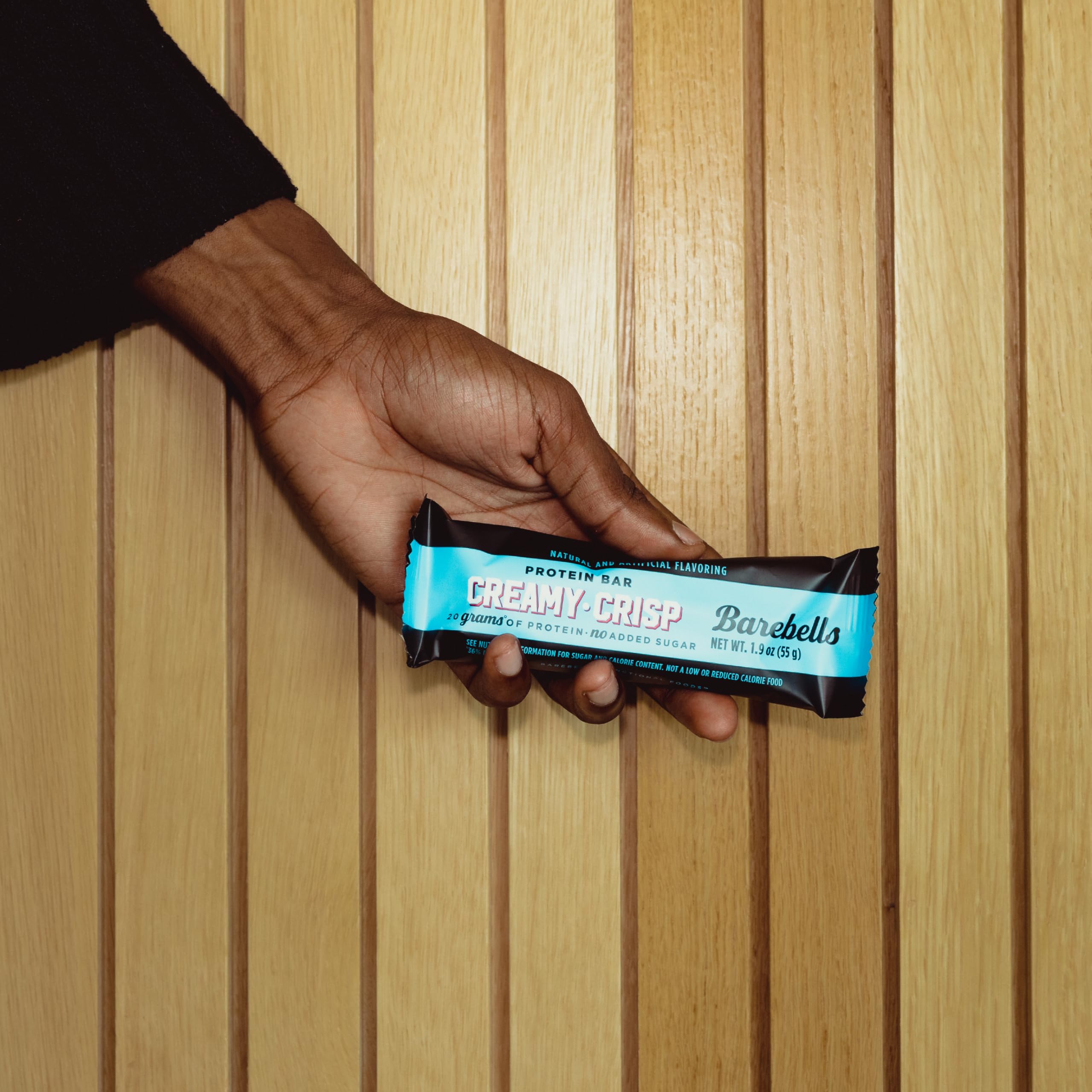 Shelf display of Barebells Creamy Crisp 12-bar box in retail setup.