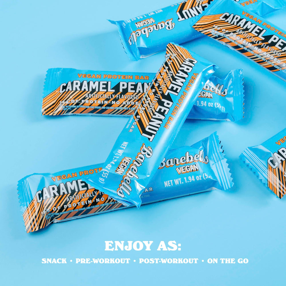 Person holding Barebells Plant Based Peanut Caramel bar for a quick snack.