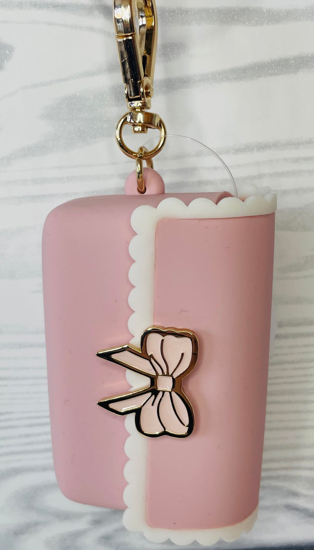 Bath and Body Works PocketBac holder in pink bow for convenient sanitizer access.