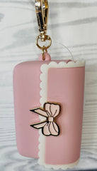 Bath and Body Works PocketBac holder in pink bow for convenient sanitizer access.