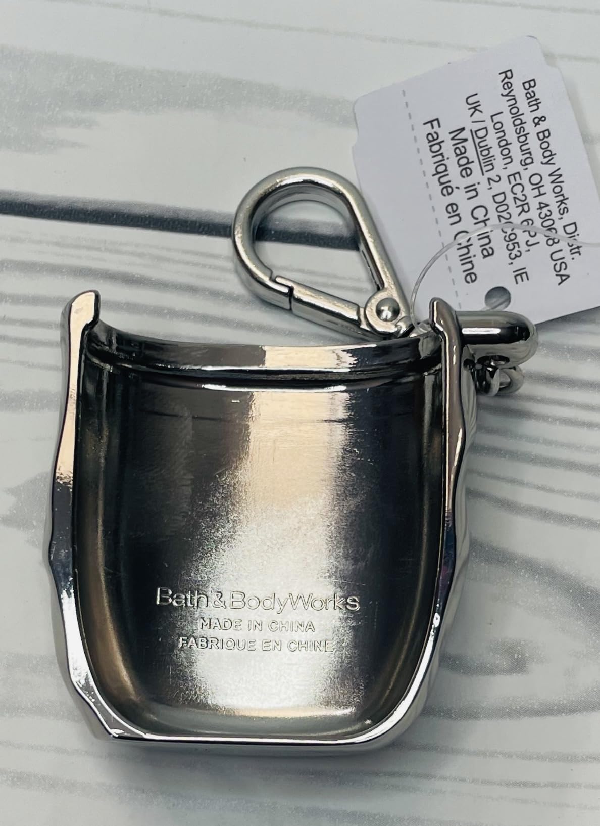Bath & Body Works Chrome Hardcase PocketBac holder with sanitizer illustrates protected, stylish travel use