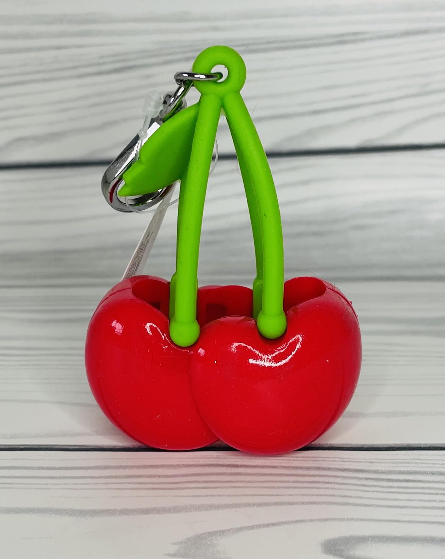 Bath & Body Works red cherries accessory detail helps keep sanitizer handy while commuting